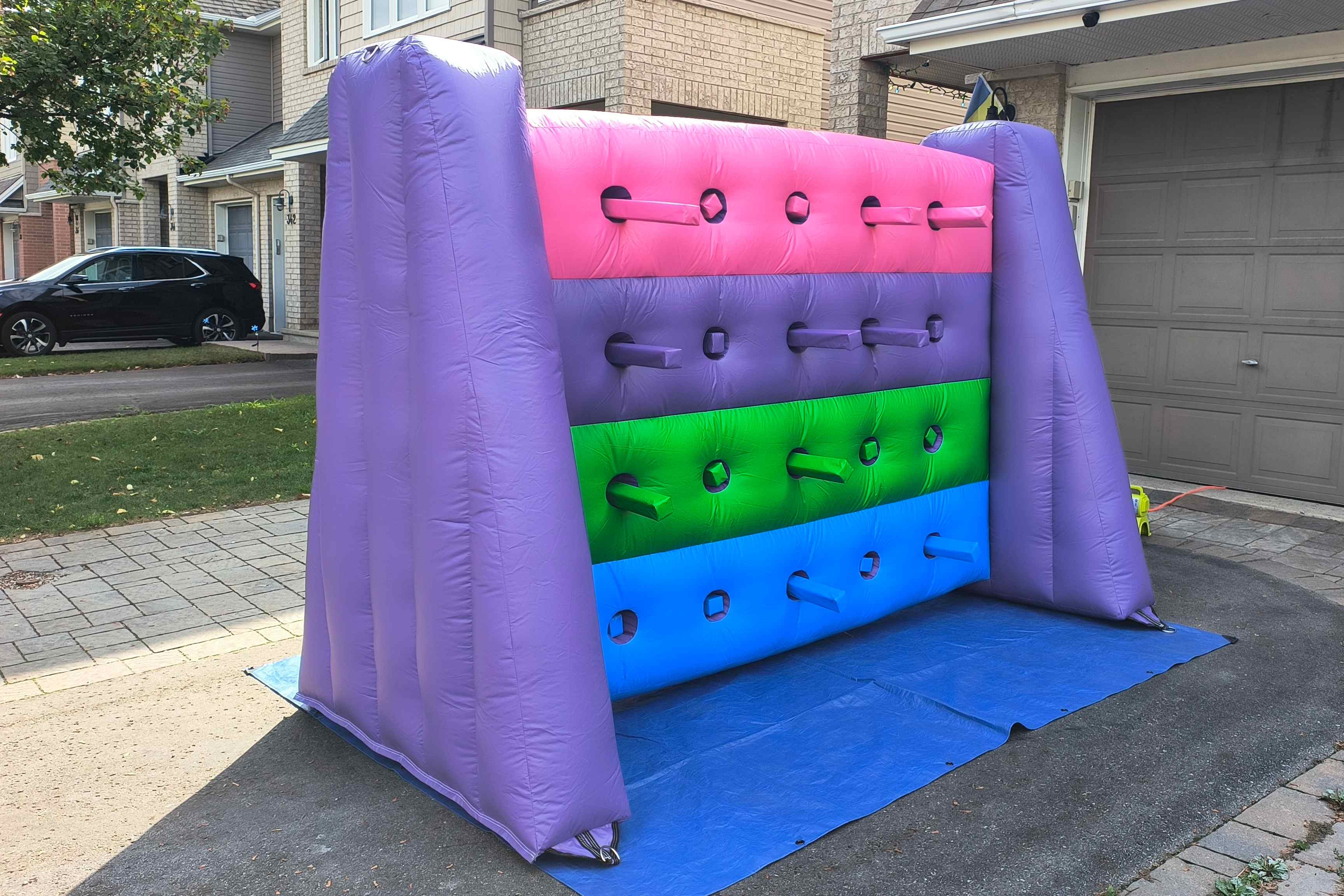 Kids playing Whack a Wall inflatable game at a birthday party in Ottawa