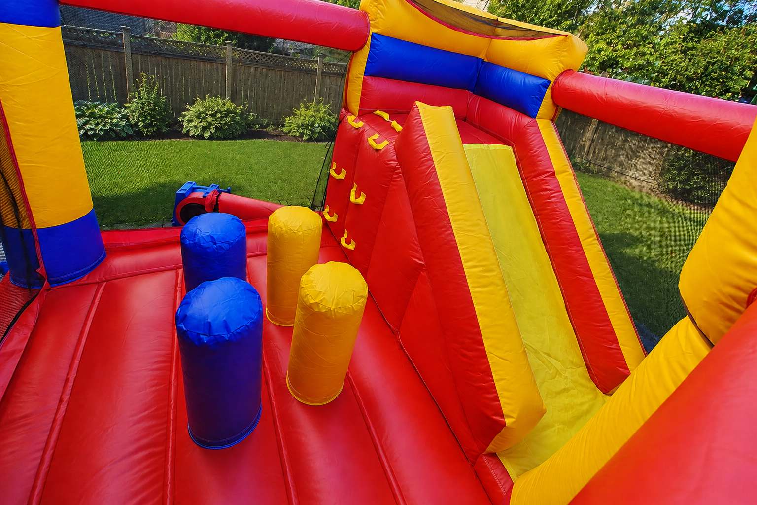 Interior of Ottawa Jump and Slide bouncy castle with obstacles, climbing wall and slide
